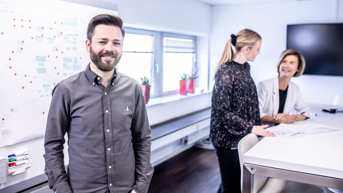 Smiling team meeting in office space with collaborative atmosphere and modern interior.